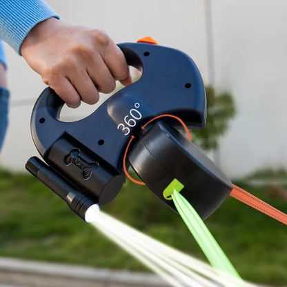 Une laisse pour chien : laisse en nylon et plastique ABS disposant de deux laisses rétractables anti-emmêlement de couleur orange et vert disposant d'une lampe d'éclairage pour les sorties nocturne.