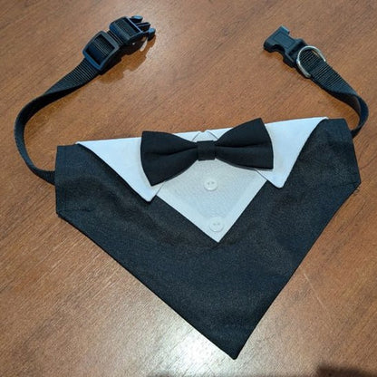 Bandana chien type smoking noir à plat avec col blanc, nœud papillon et sangle à clip réglable.