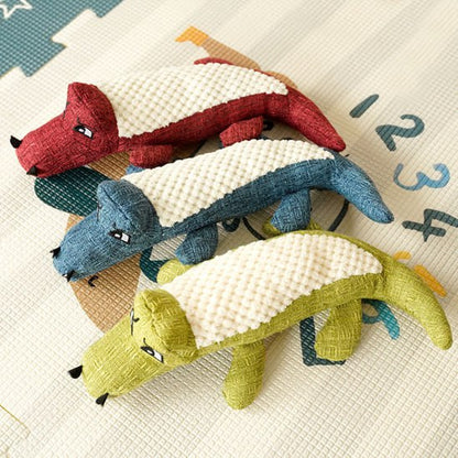Trois modèles de peluche pour chien crocodile sur un tapis avec les chiffres 1, 2, 3 et 4.