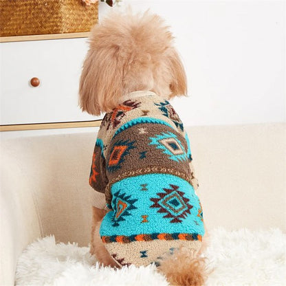 Vue de dos d'un chien portant un pull pour chien à motifs ethniques bleu, orange et marron.
